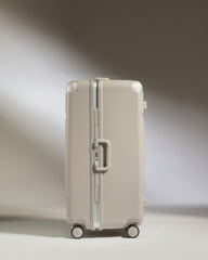 Beige suitcase on a gradient background