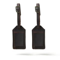 Two brown leather luggage tags on a white background