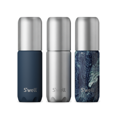 Three S'well water bottles with different designs on a white background
