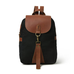 Black backpack with brown leather accents on a white background