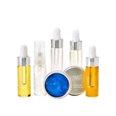 Collection of skincare products including bottles and a balm on a white background