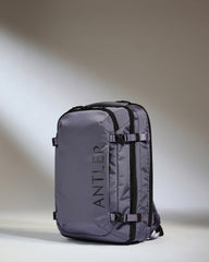 Gray backpack with 'ANTLER' branding on a gradient background