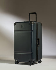 Black suitcase with a brand logo on a gradient background