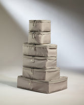 Set of beige storage cubes stacked on a neutral background