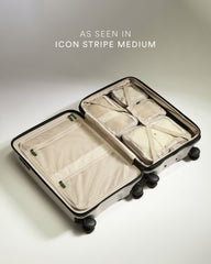 Open suitcase with packing cubes on a light background