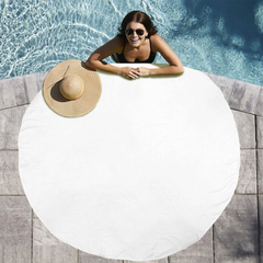 Woman lounging on a white inflatable pool float with a straw hat nearby, by a pool.