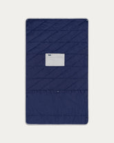 Navy quilted cover with a brand label on a light gray background