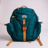 Teal backpack with orange straps on a light gray background