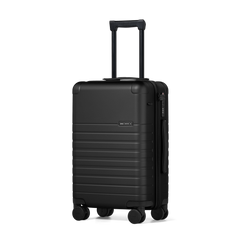 Black suitcase with wheels on a white background