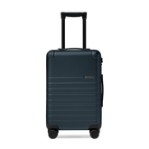 Dark blue suitcase with a visible brand logo on a white background
