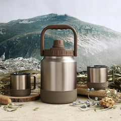 Stainless steel thermos and mugs with a mountainous landscape in the background