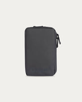 Black travel pouch on a light gray background