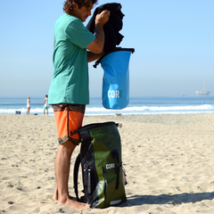 Person on a beach with COR bags