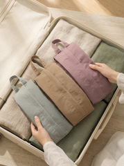 Folded fabric bags in various colors inside an open suitcase.