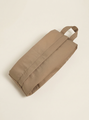 Beige bag with handles on a beige background