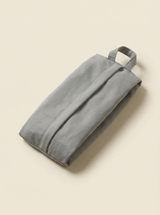 Gray fabric bag with a handle on a beige background