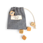 Set of wooden dice with a striped bag labeled 'roll 'em dice set' on a white background