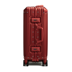 Red suitcase with a textured surface on a white background