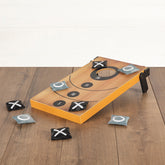 Cornhole board game with bean bags on a wooden floor