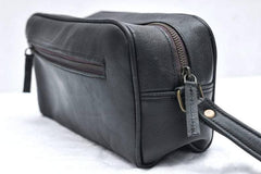 Black leather bag with a strap on a white background