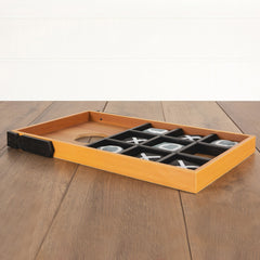 Wooden tic-tac-toe board with pieces on a wooden surface