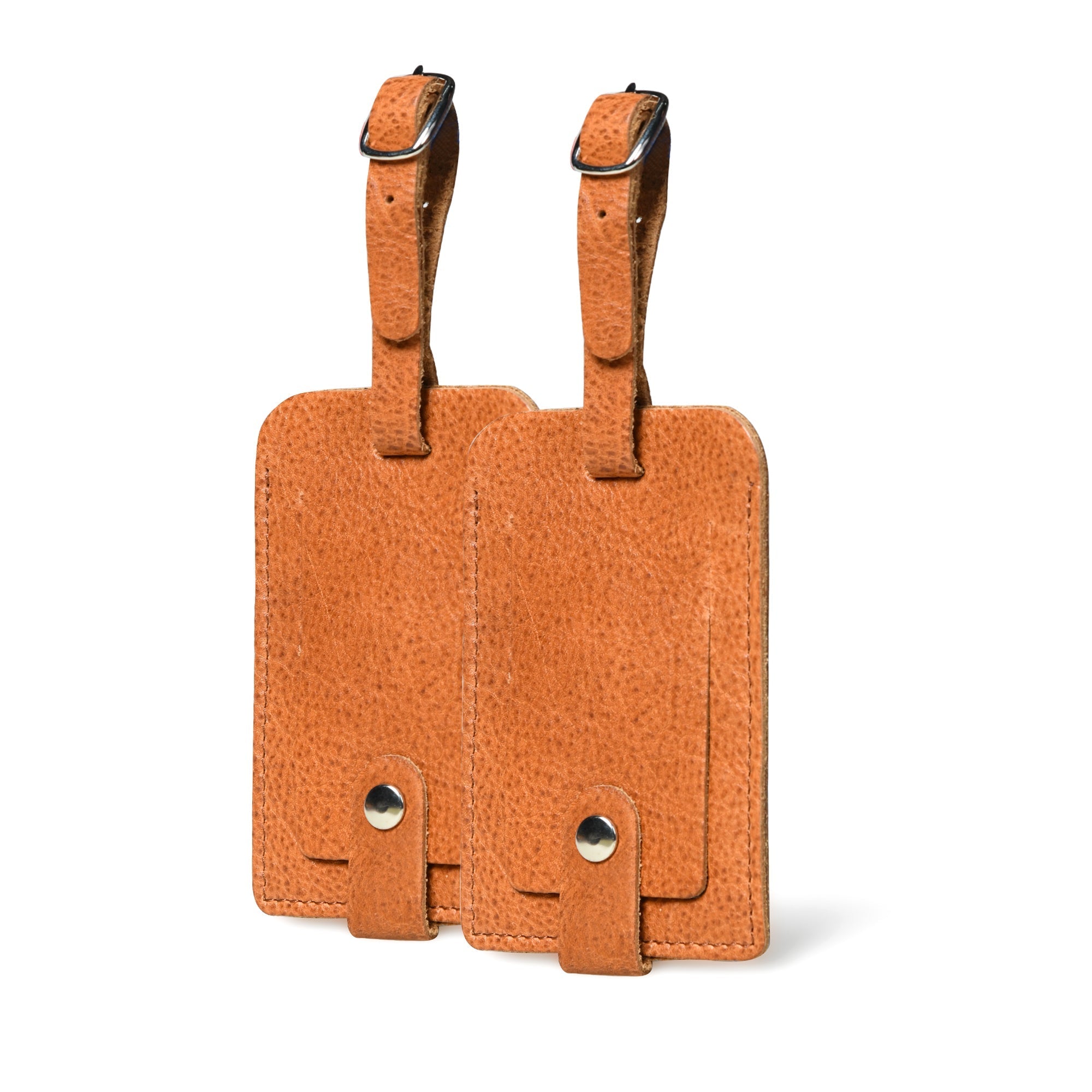Two brown leather luggage tags on a white background