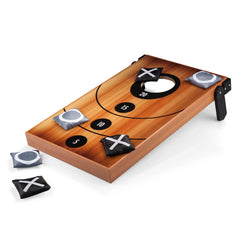Wooden cornhole board with bean bags on a white background