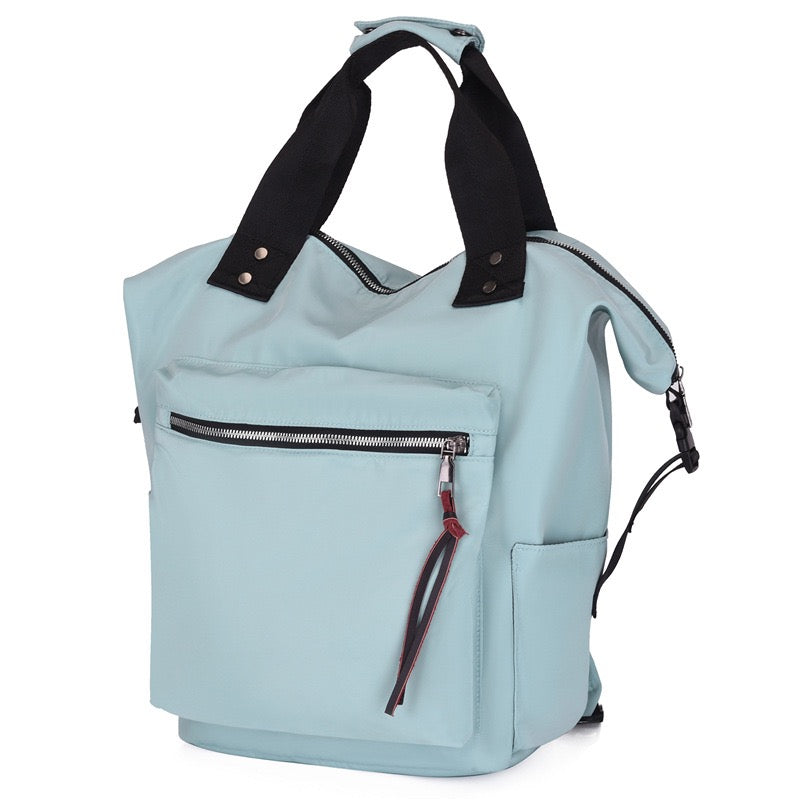 Light blue backpack with black straps on a white background
