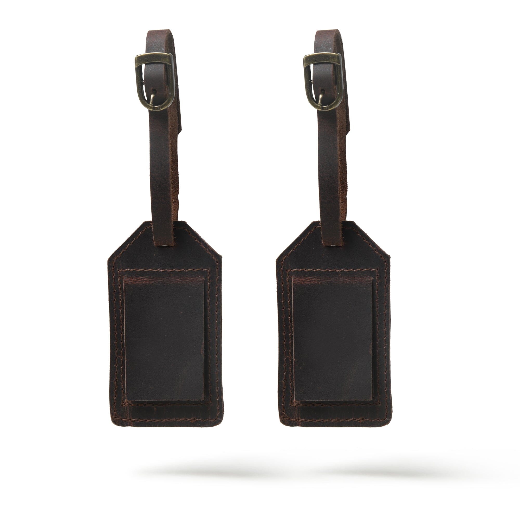 Two brown leather luggage tags on a white background