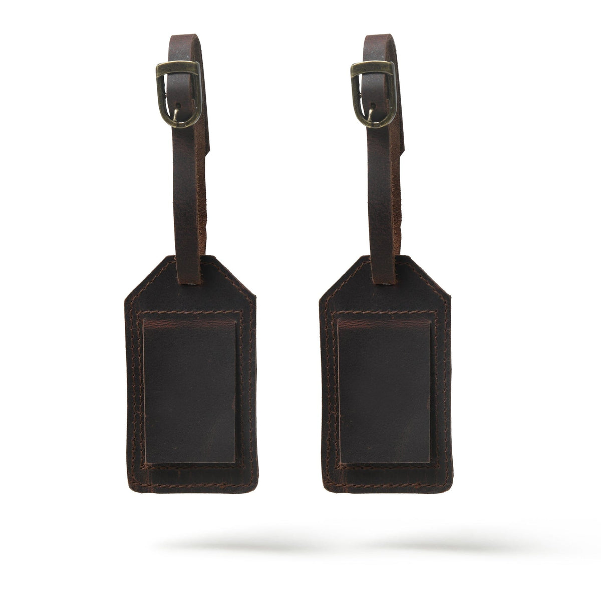 Two brown leather luggage tags on a white background
