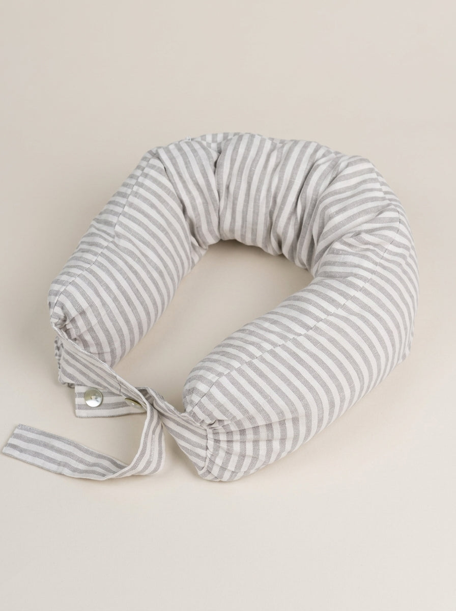 Striped travel neck pillow on a beige background
