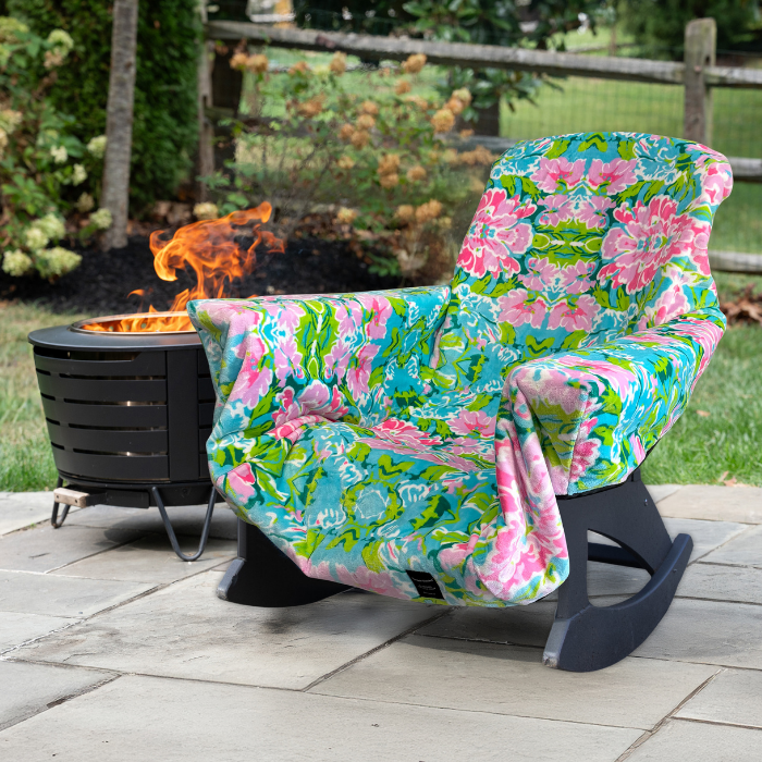 Floral-patterned chair with a fire pit in the background