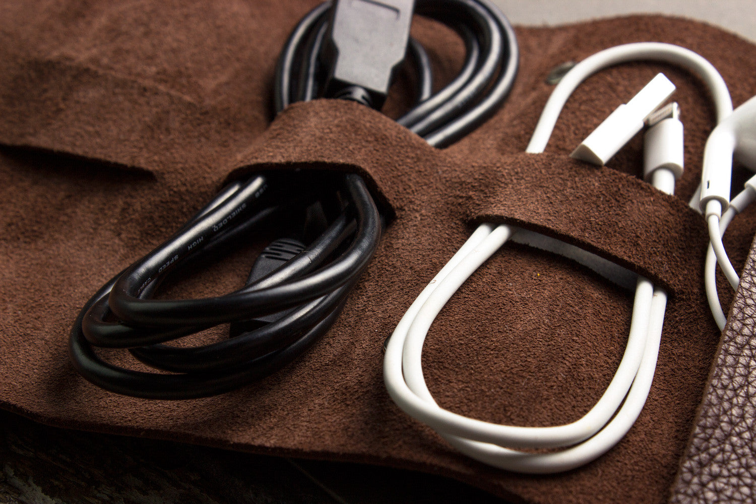 Black and white cables on a brown textured surface