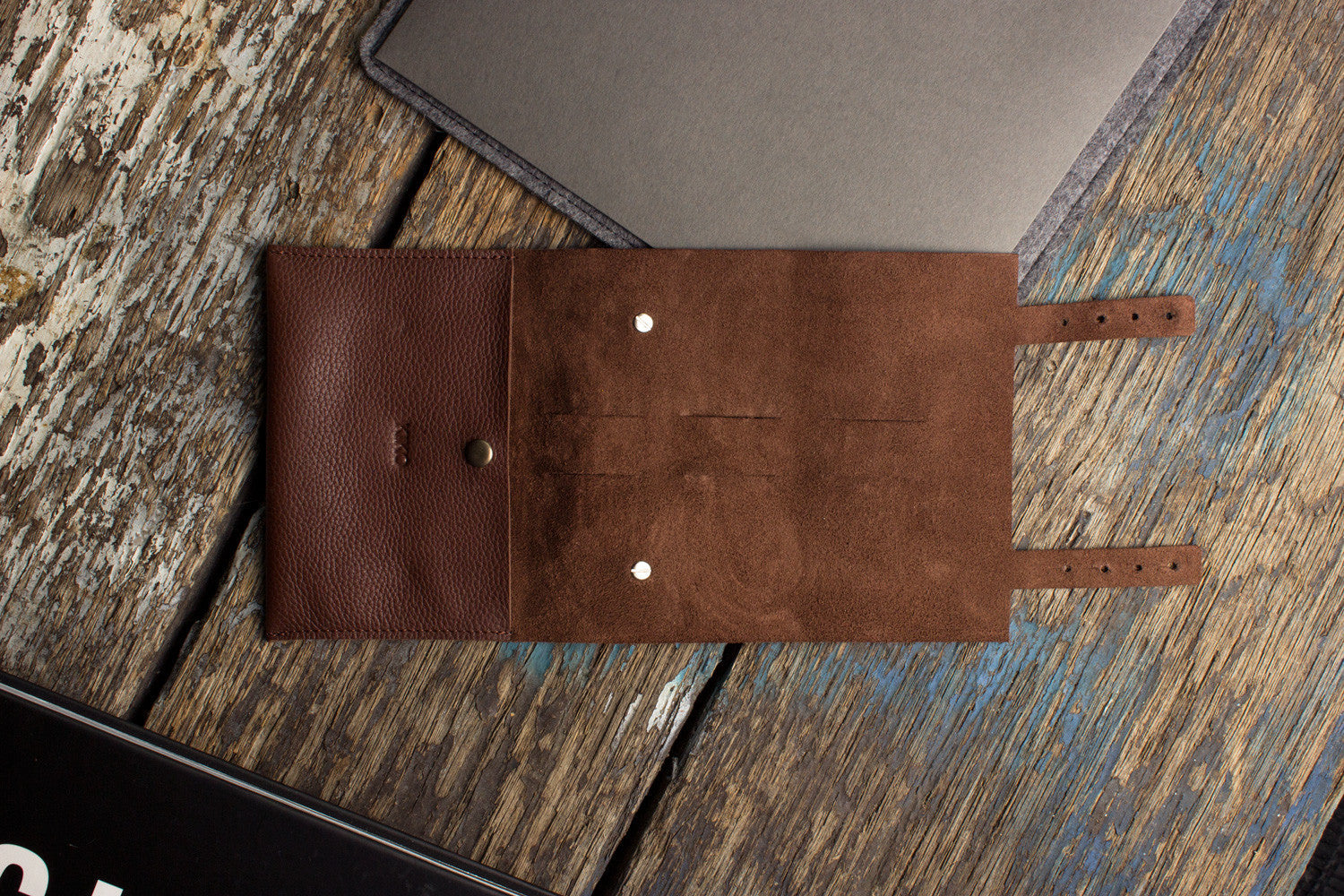 Brown leather pouch on a wooden surface