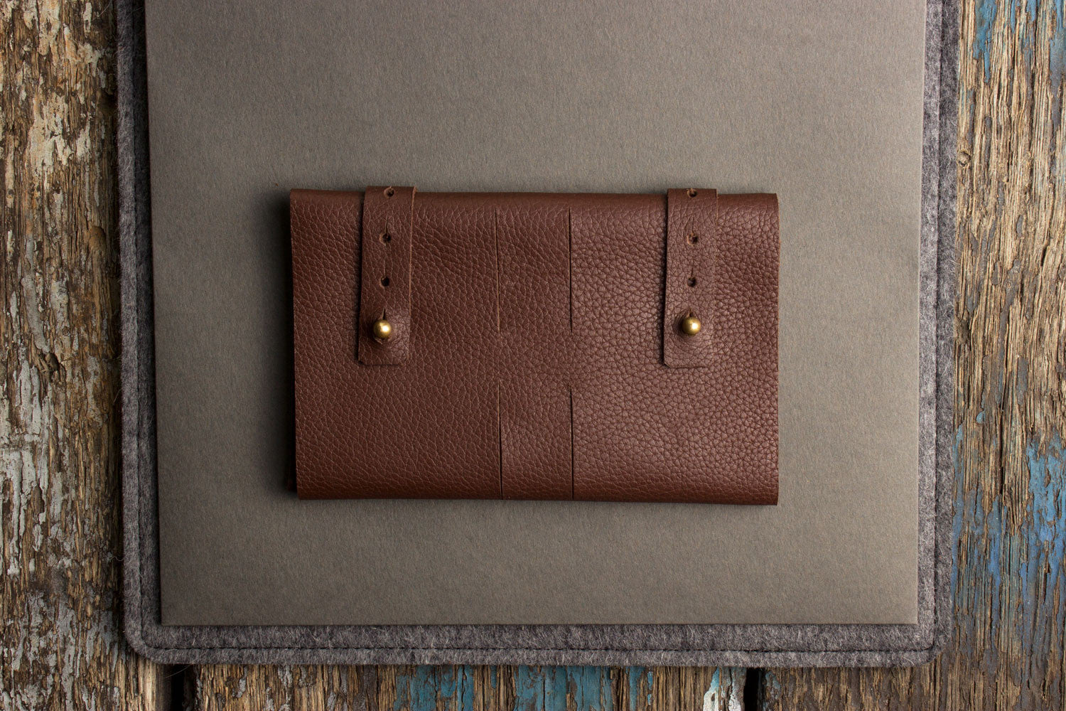 Brown leather wallet on a textured surface