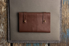 Brown leather wallet on a textured surface
