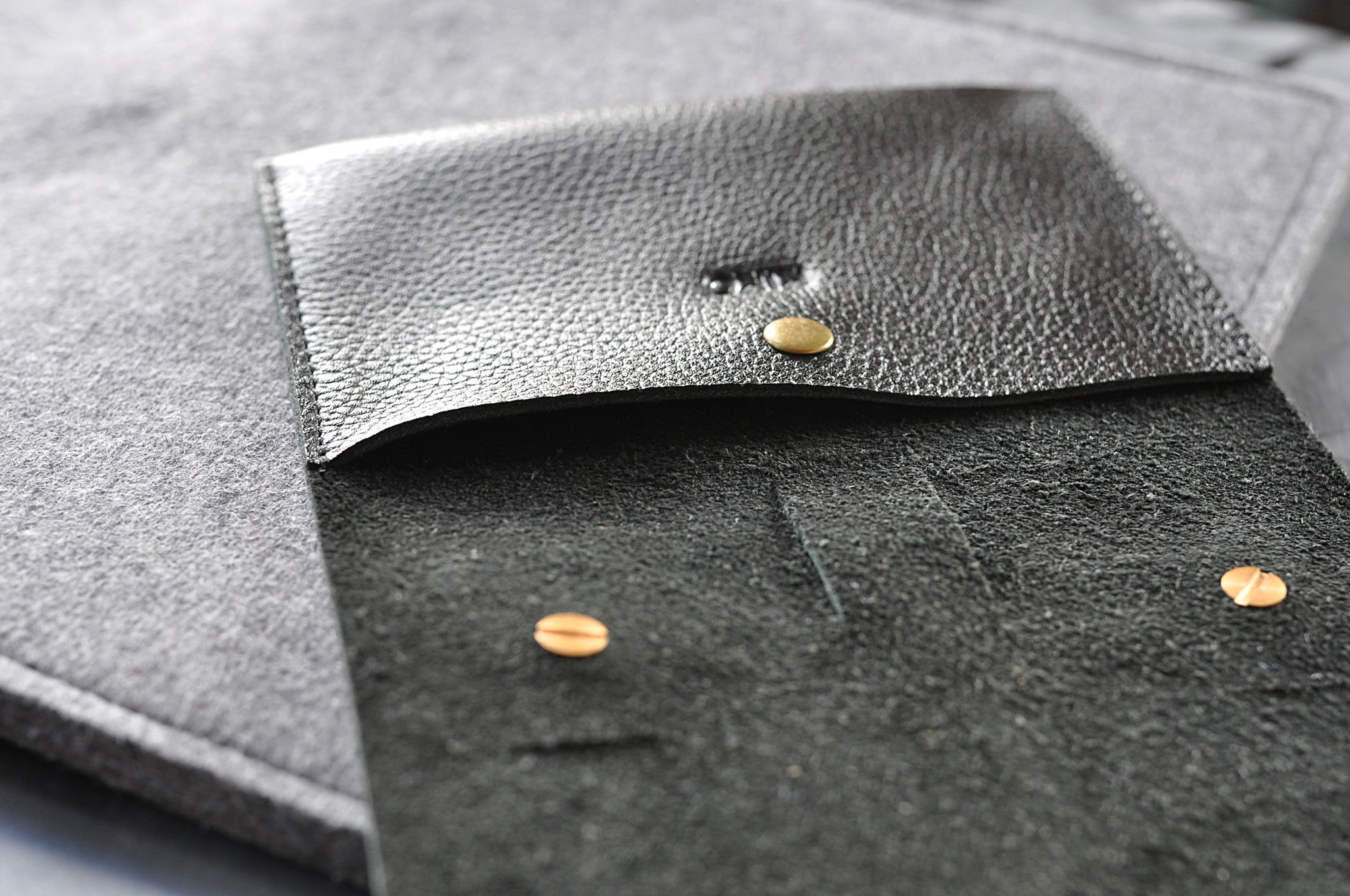 Close-up of a textured gray fabric surface with gold buttons.