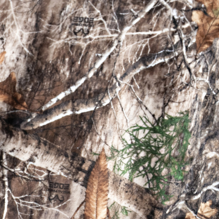 Close-up of a camouflage pattern with tree branches and leaves.