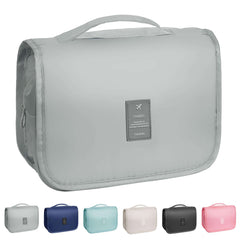Gray toiletry bag with 'Travel' label on a white background, surrounded by other color options.