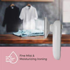 White iron with steam feature on a wooden table with clothes in the background, labeled 'Fine Mist & Moisturizing Ironing'.