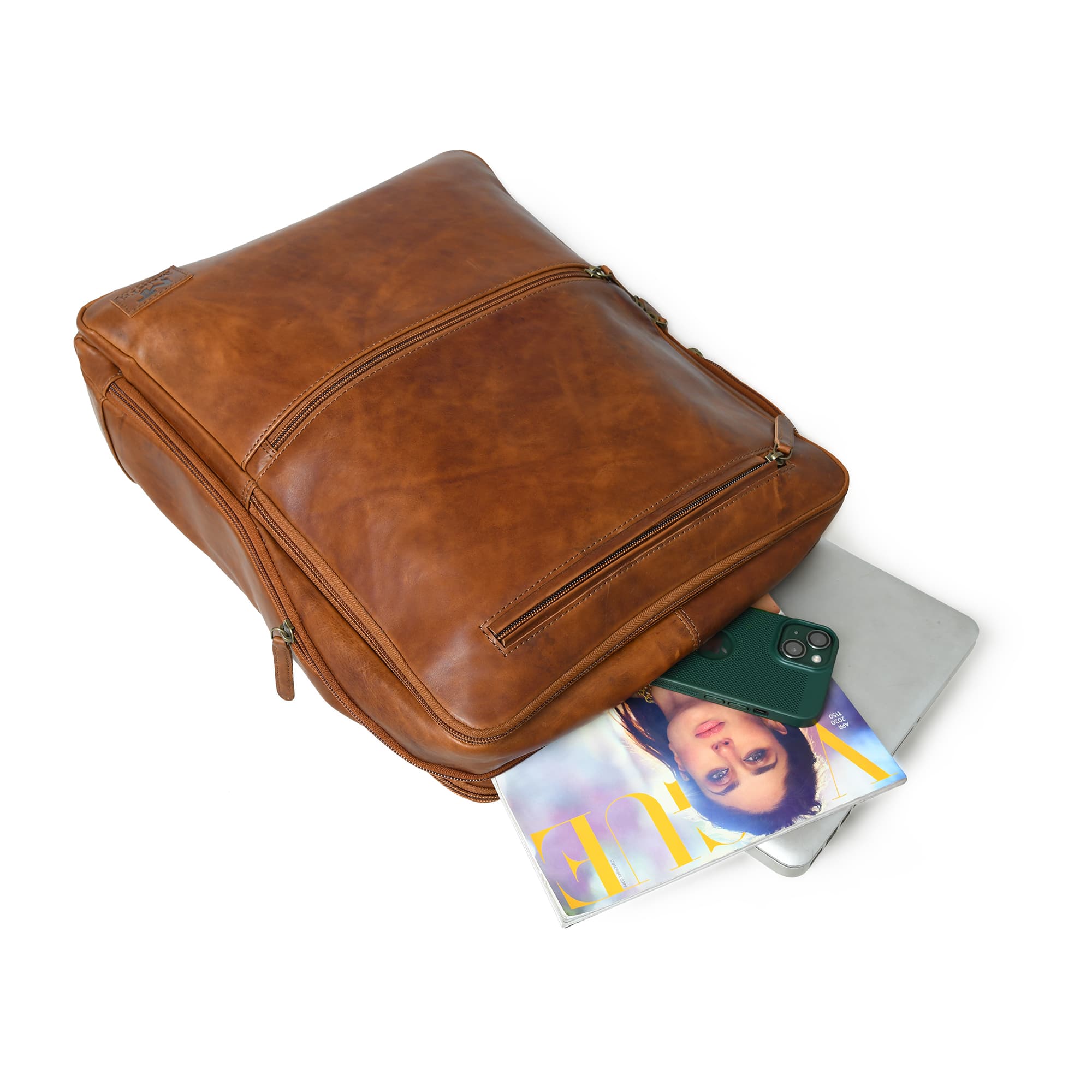 Brown leather backpack with items spilling out on a white background