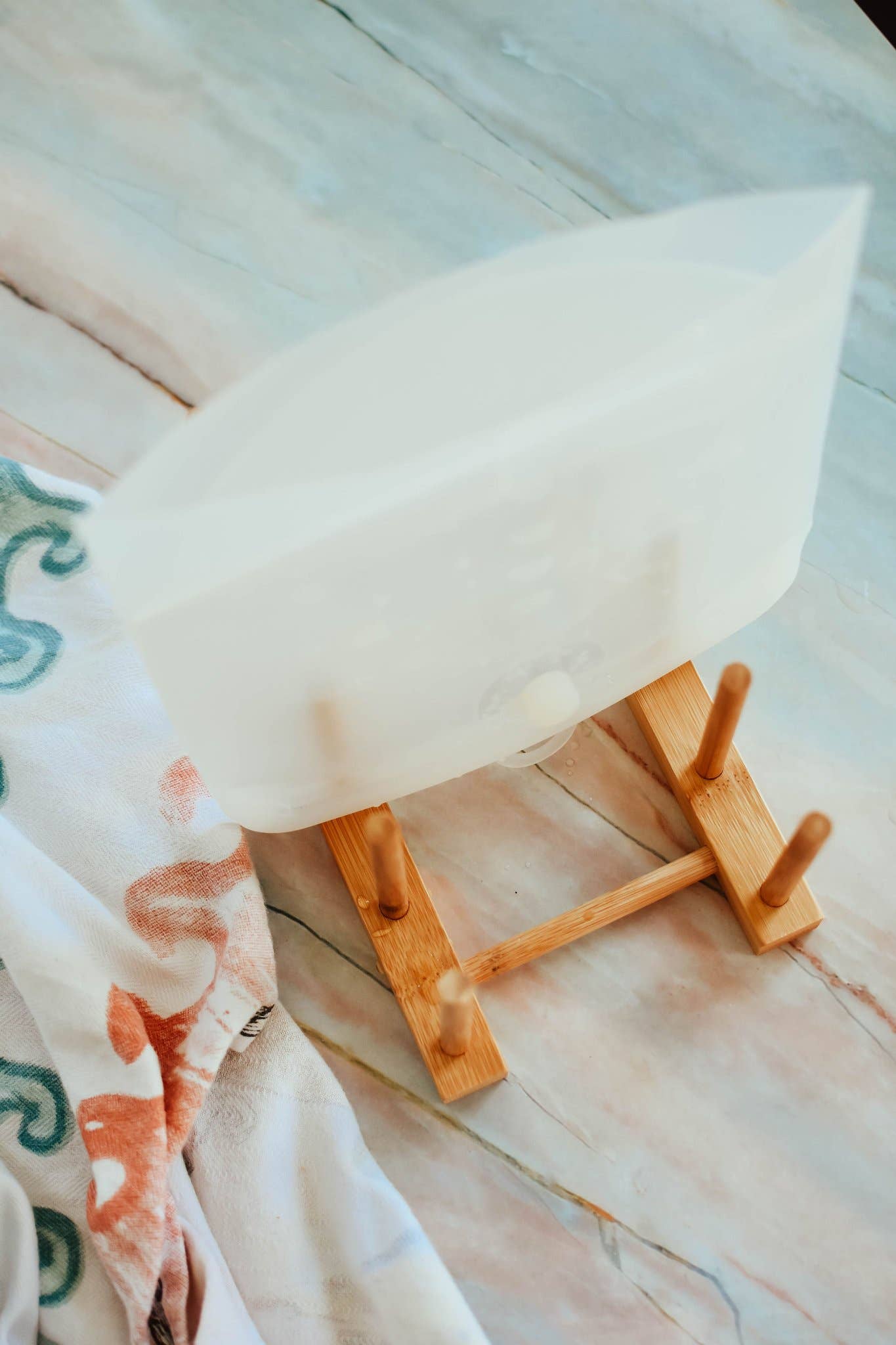 White surfboard on a wooden stand with a blurred background