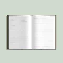 Open book with lined pages on a light green background