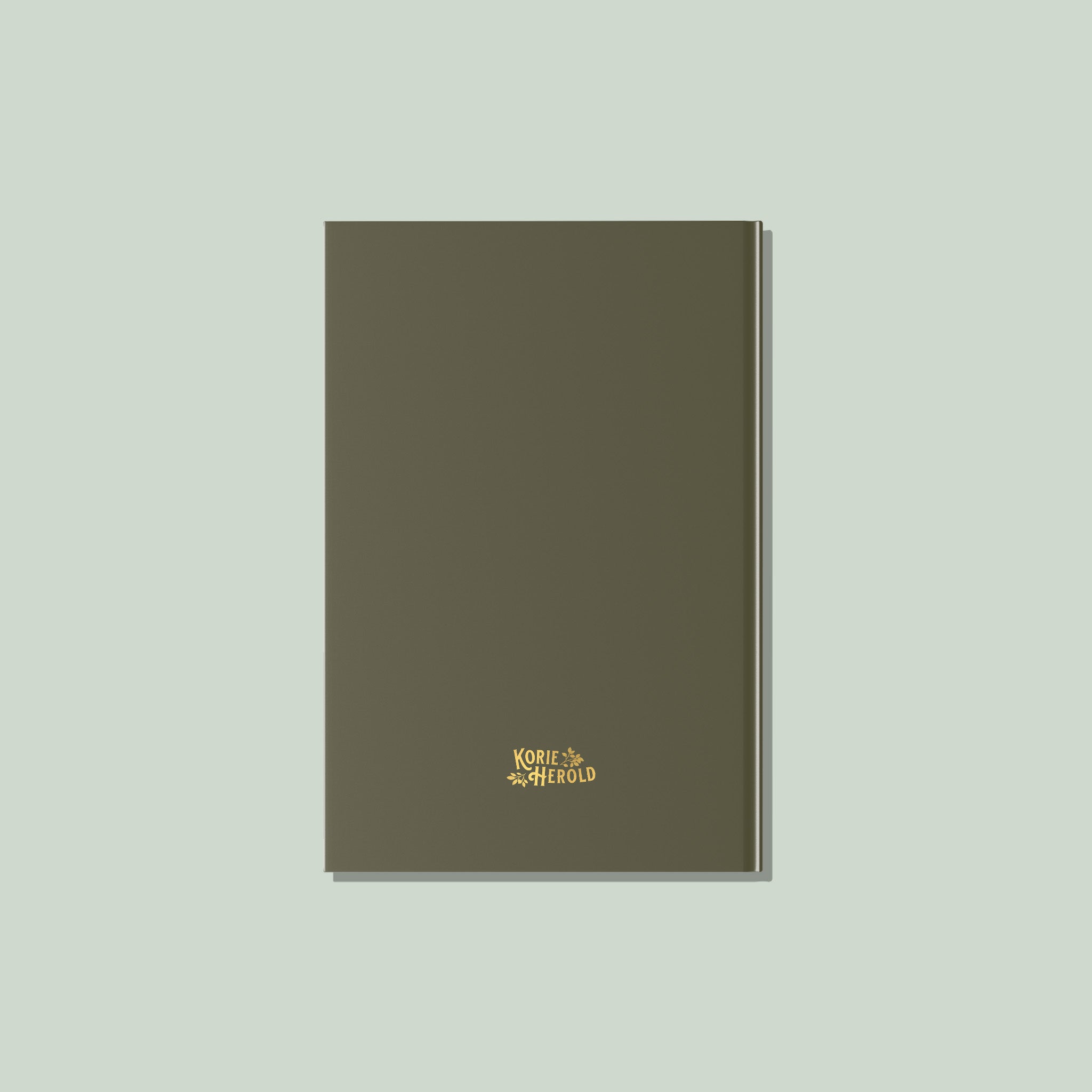 Dark green notebook with a gold logo on a light gray background