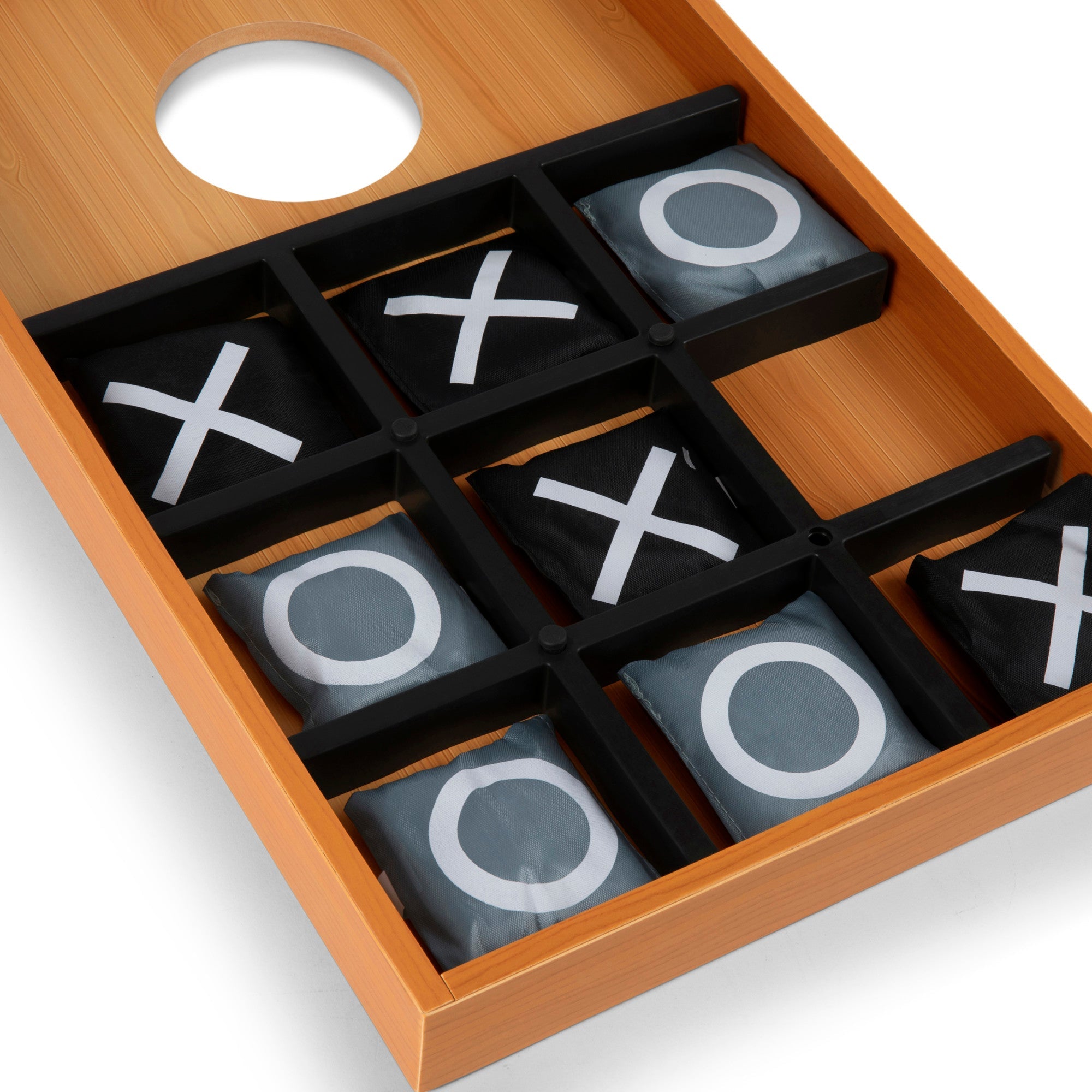 Wooden tic-tac-toe game set with pieces showing 'X' and 'O' on a white background