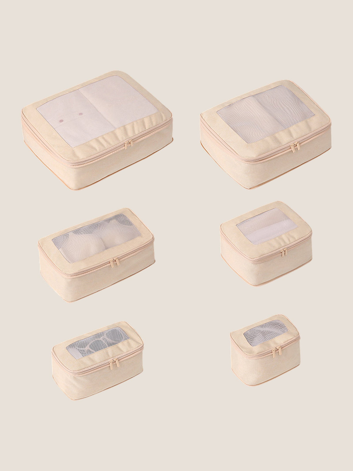 Set of six beige travel packing cubes with clear windows on a light beige background