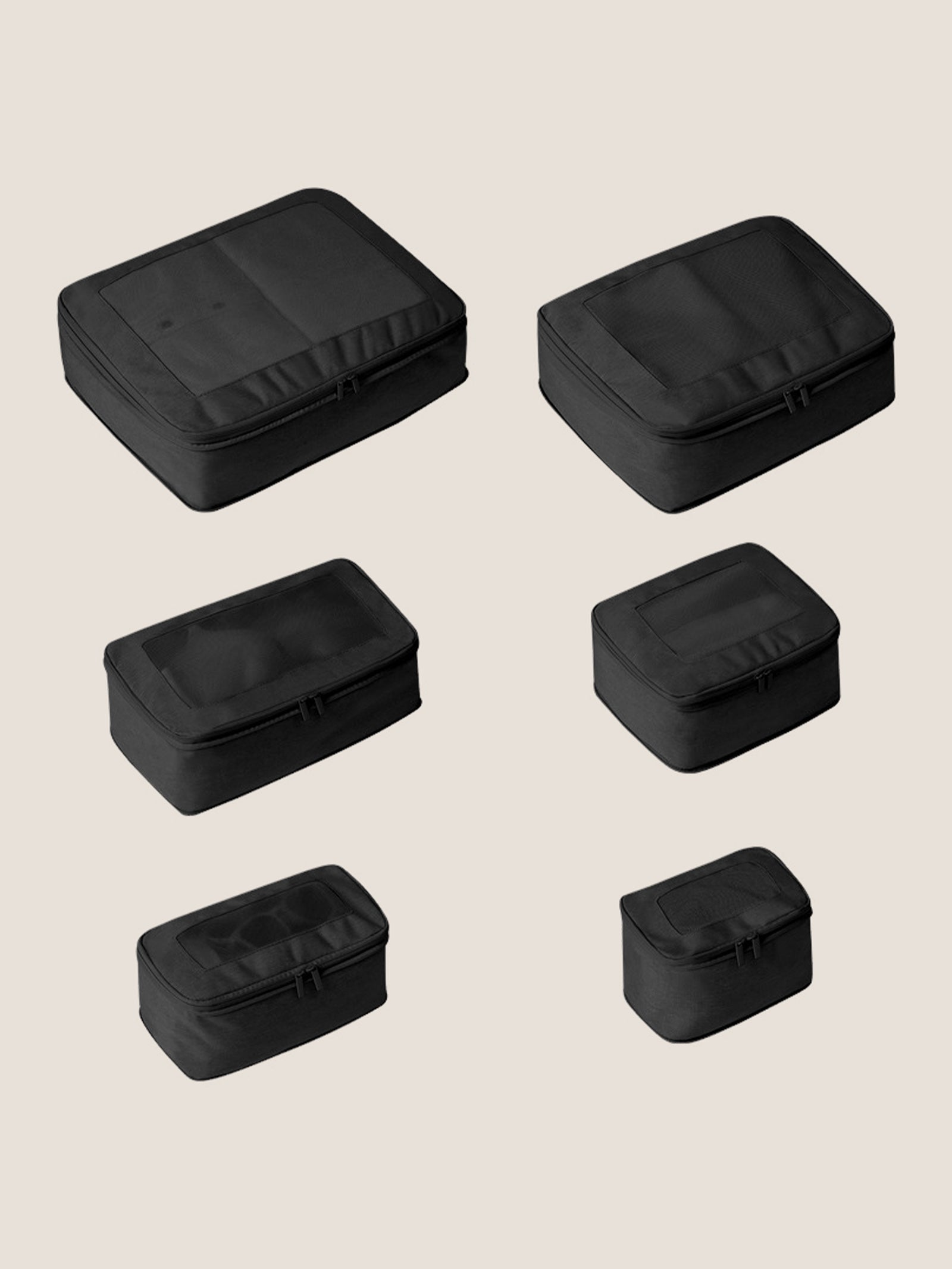 Set of six black rectangular travel cases on a beige background