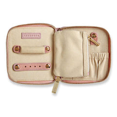 Beige travel wallet with pink accents on a white background