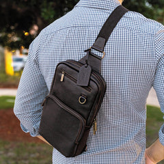 Person wearing a black leather crossbody bag outdoors