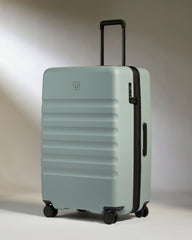 Light blue suitcase with black handle and wheels on a neutral background